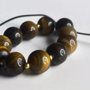 Pulsera ojo de tigre con perla dorada